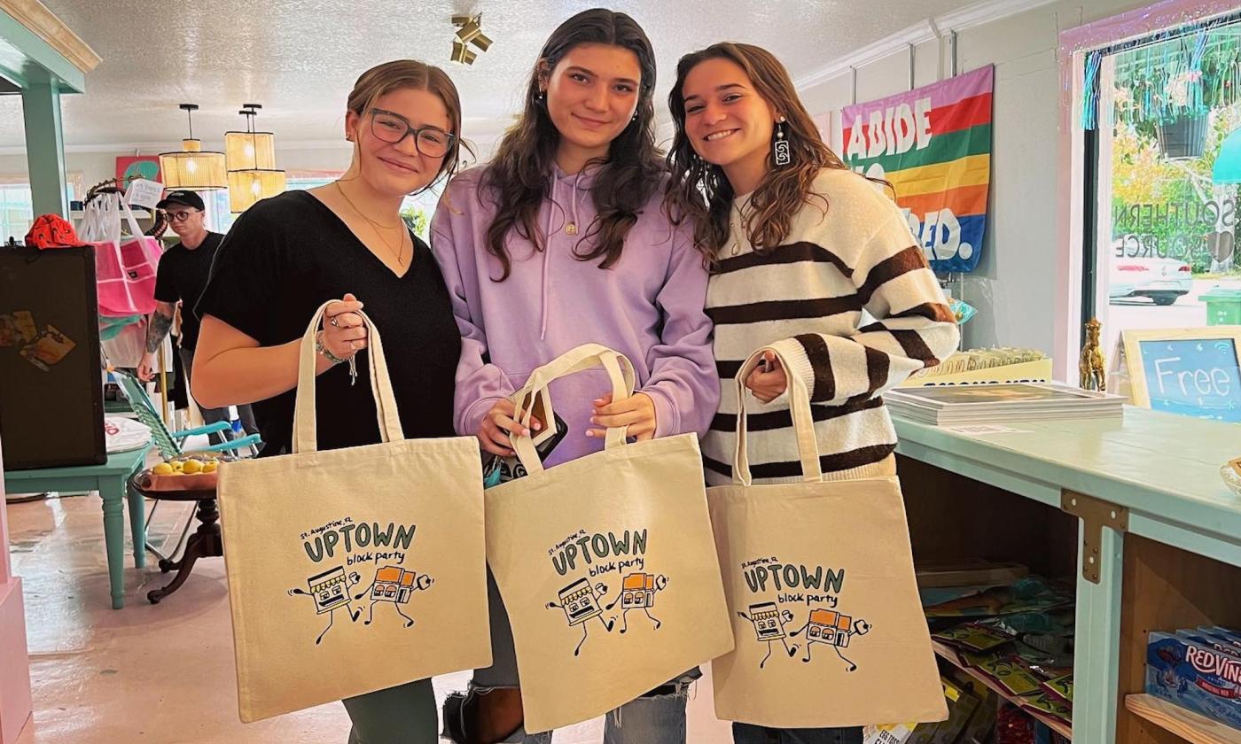 Three gals with their Uptown Block Party tote bags