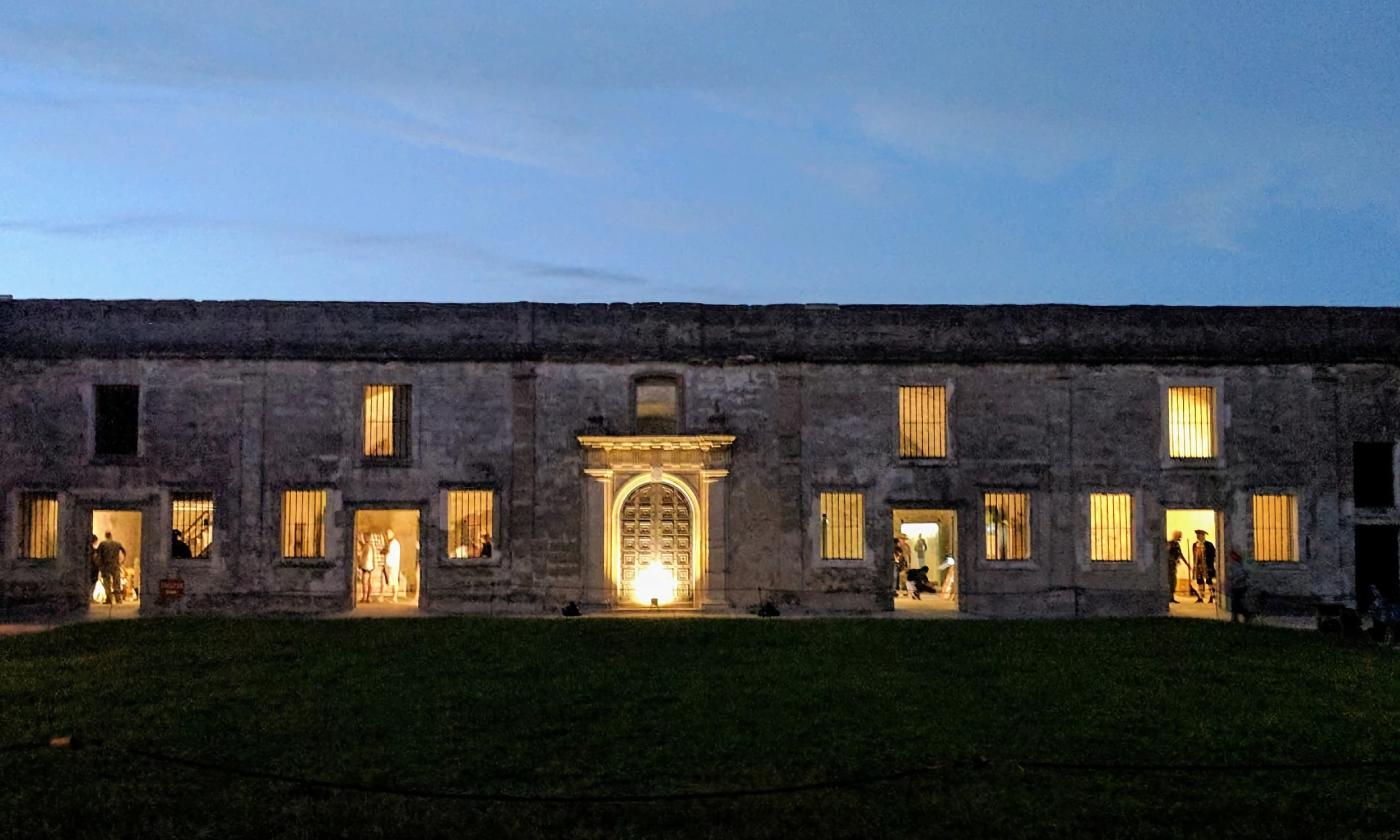 The Castillo de San Marcos at night, with candlelight and campfires illuminating reenactors