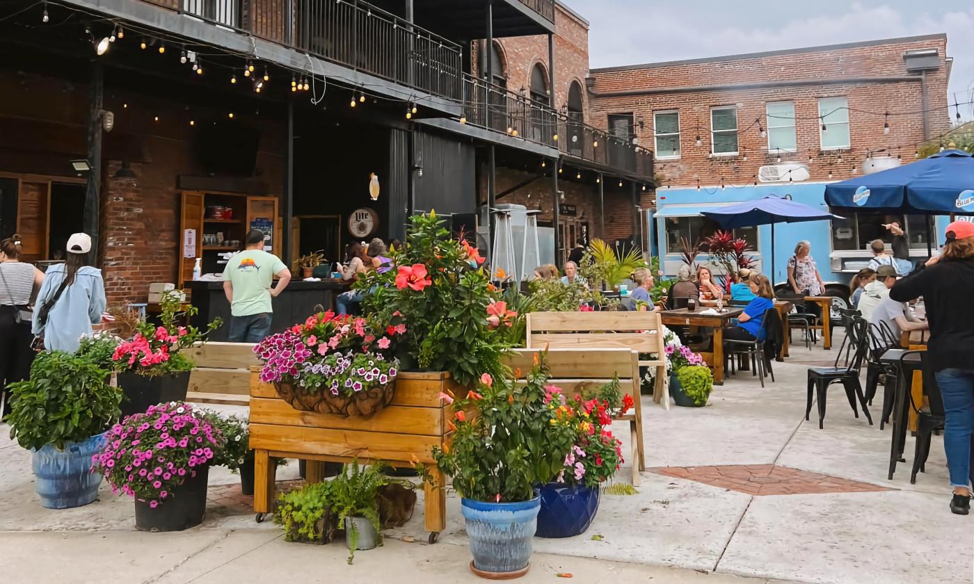 An outdoor patio with a food truck and bar