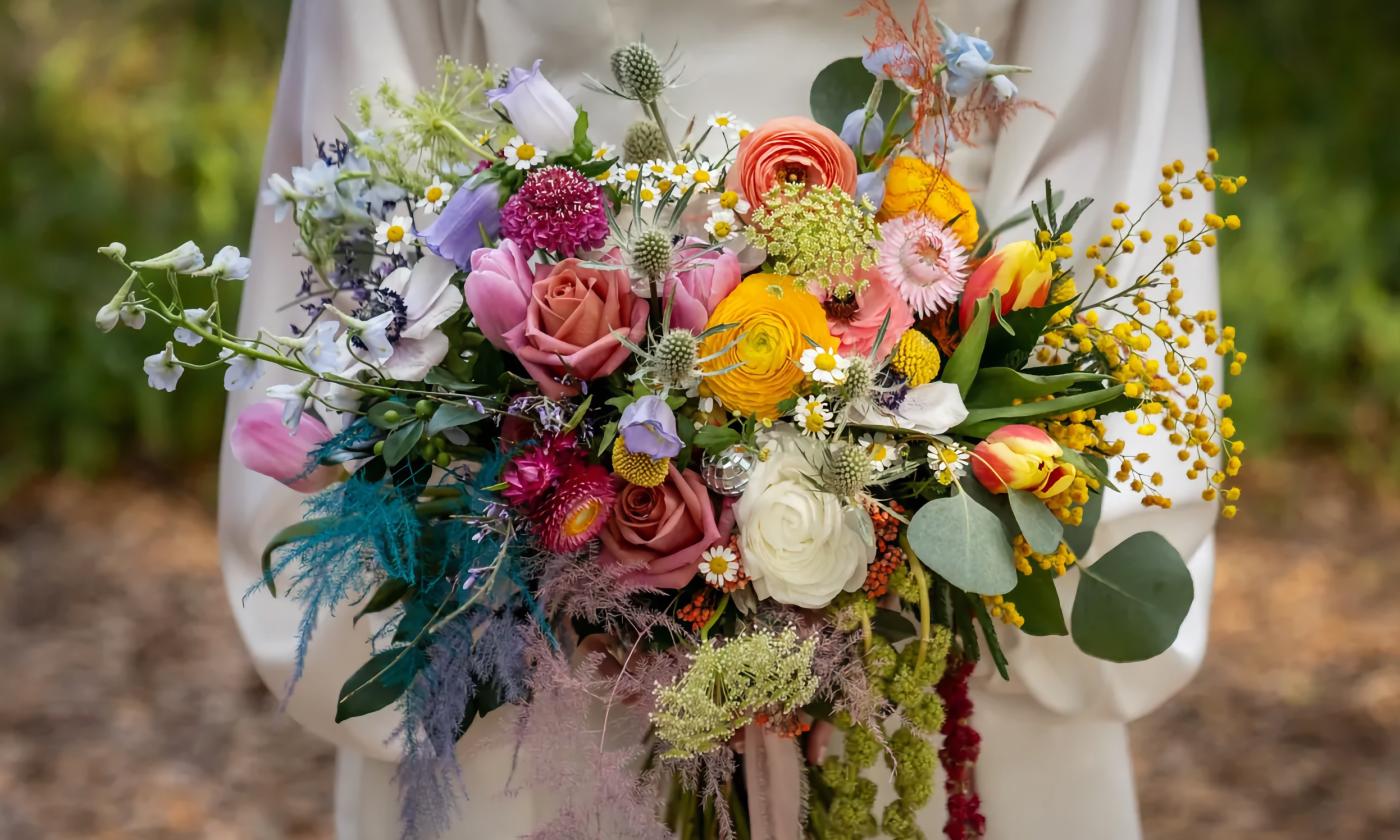 A colorful bouquet held by a bride