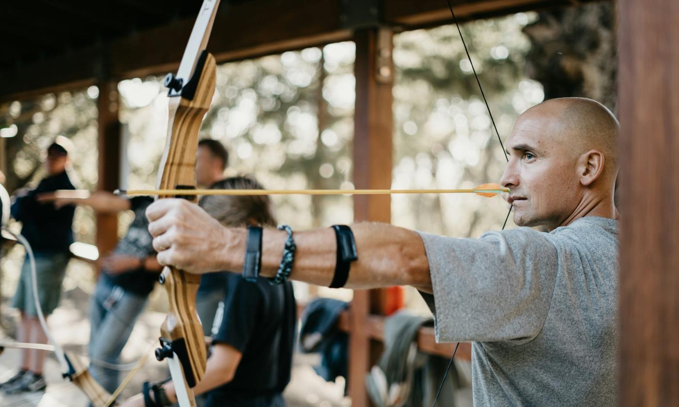 Archer taking aim with a recurve bow