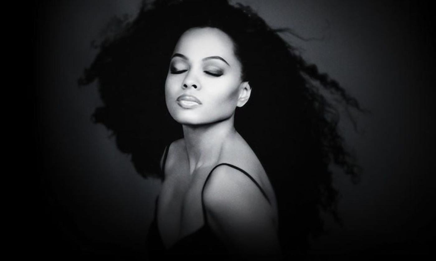 Diana Ross closes her eyes and poses in a black and white photograph.