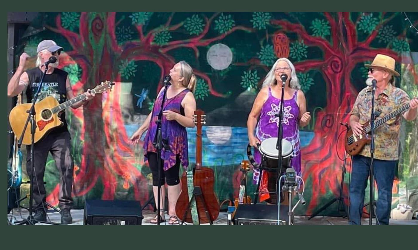 The folk band In Good Company onstage, playing