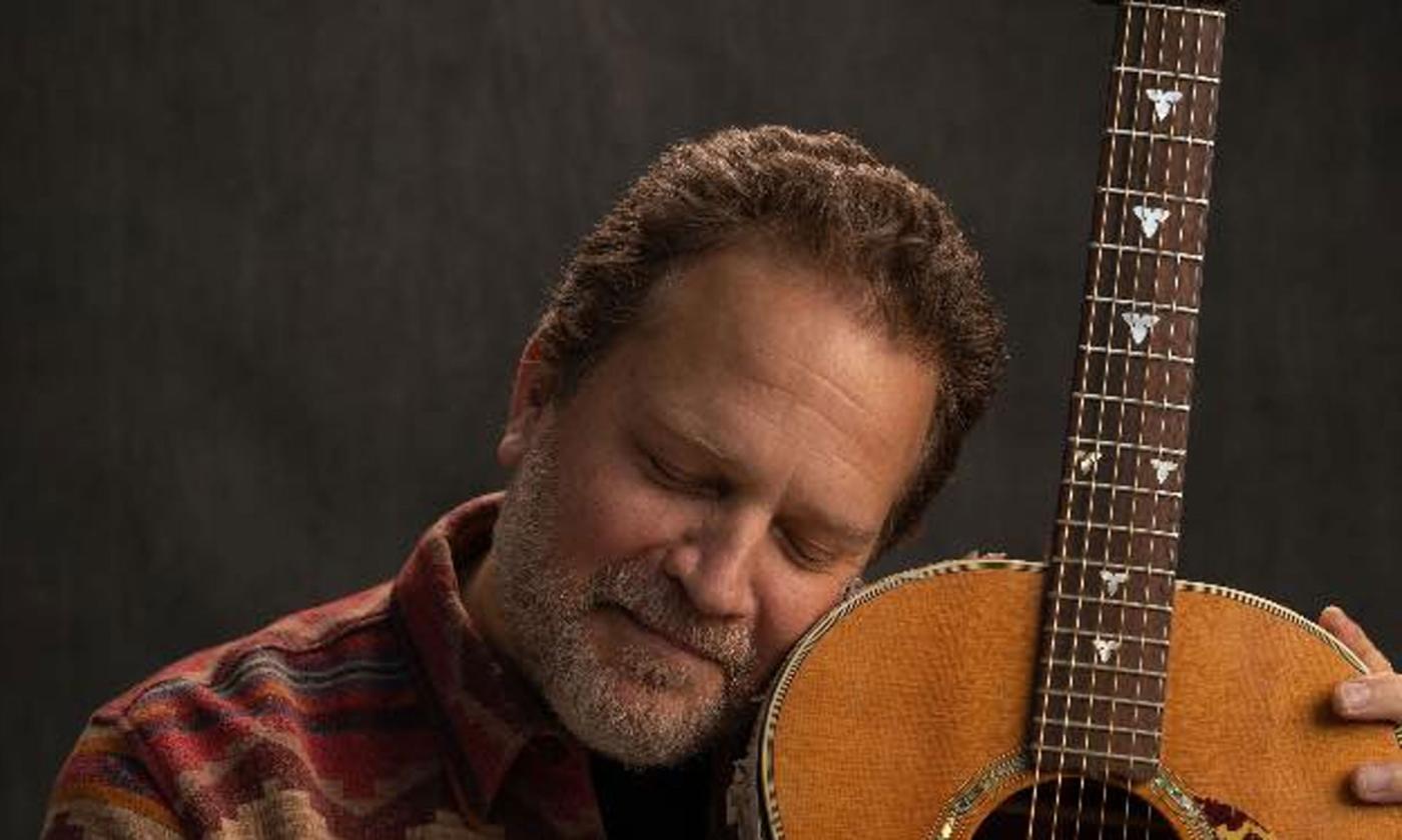 Marc Douglas Berardo leaning onhis guitar; image by Joshua Behan