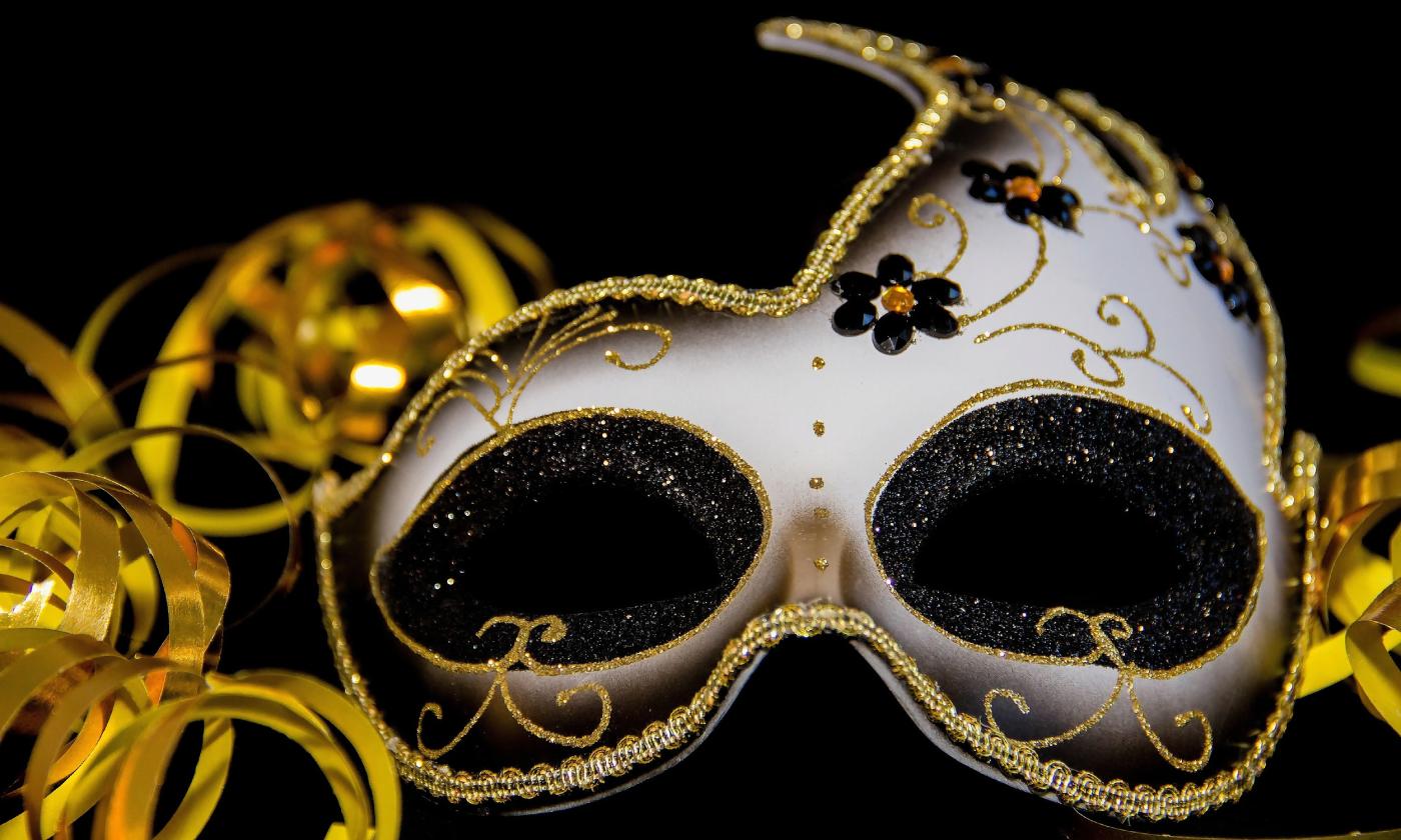 An ornate white and gold mask for a masked ball