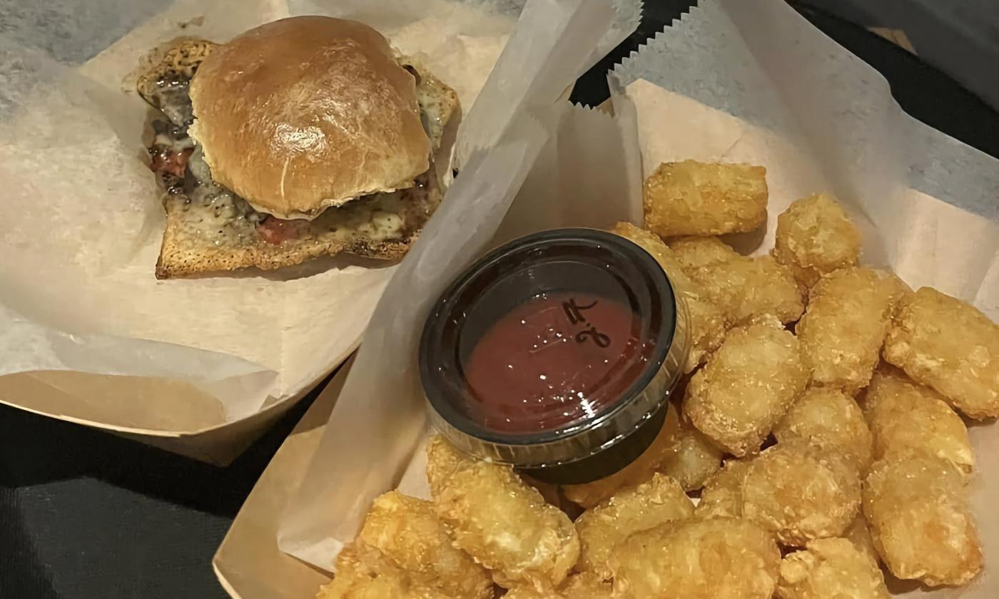 A portabella slider and tater tots served