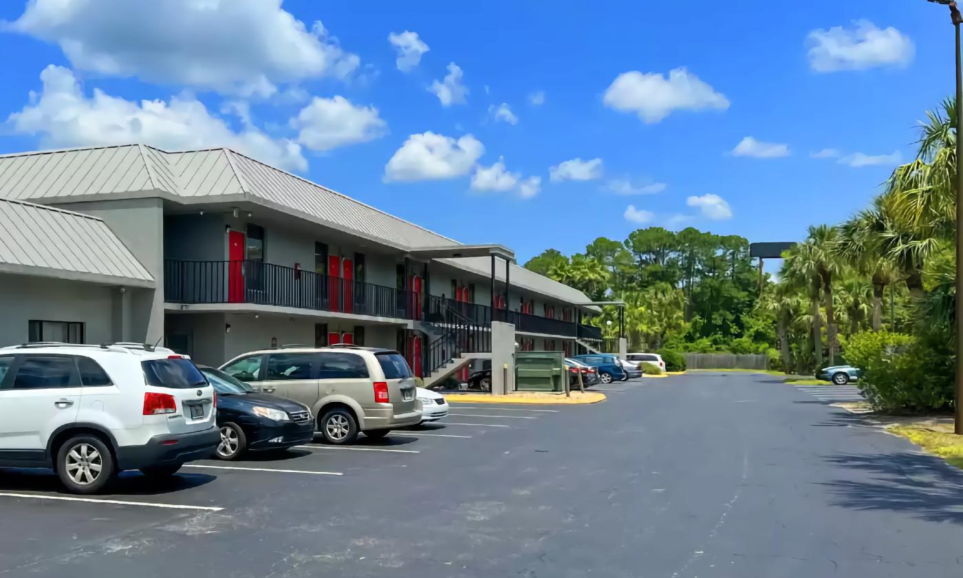 The parking lot at this green two-story hotel is convenient for rooms at both levels