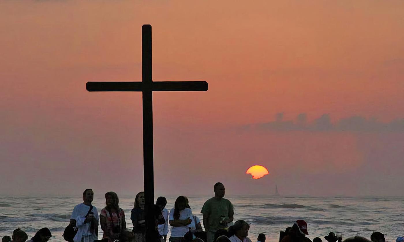 A sunrise church service taking place at the beach