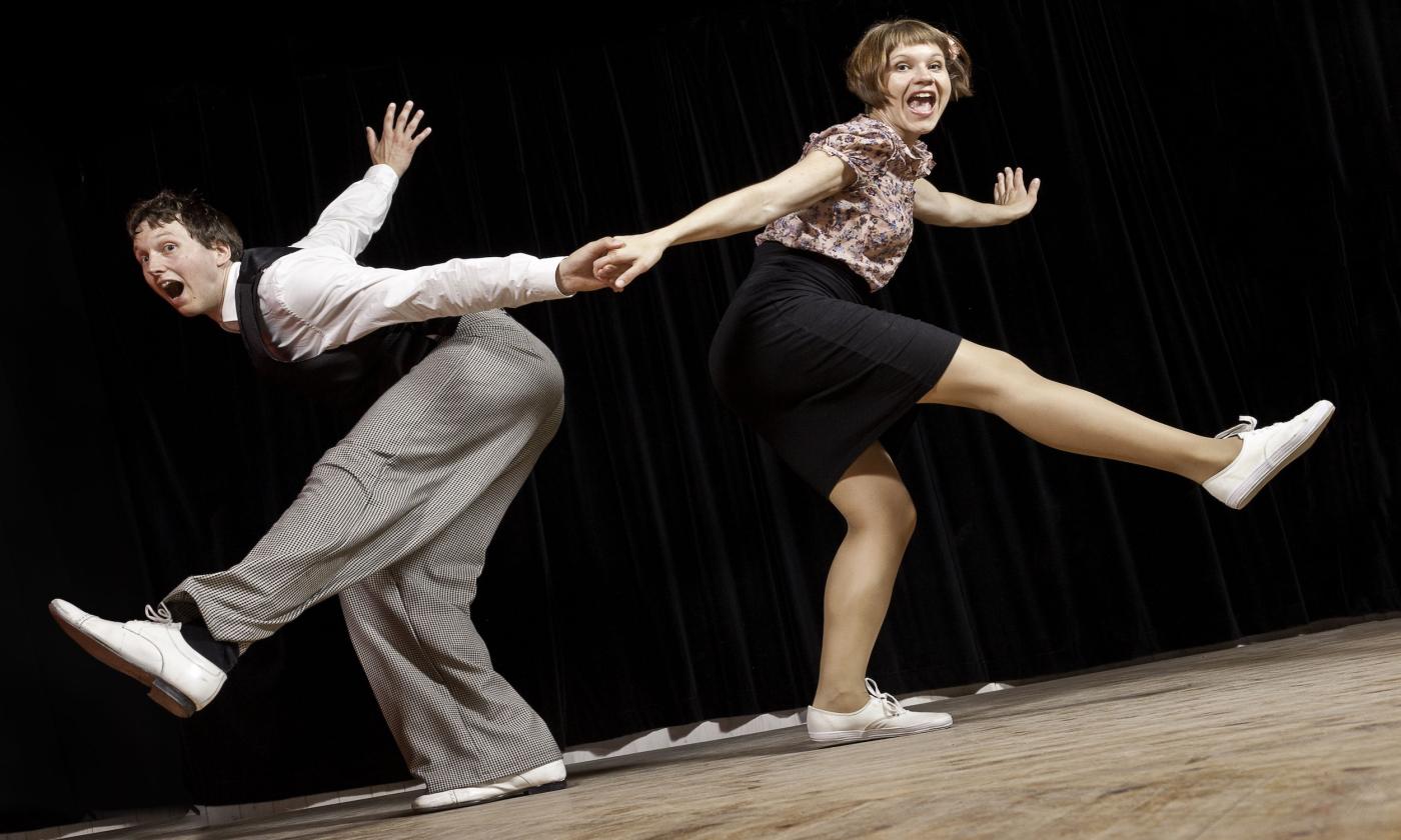 A couple swing dancing