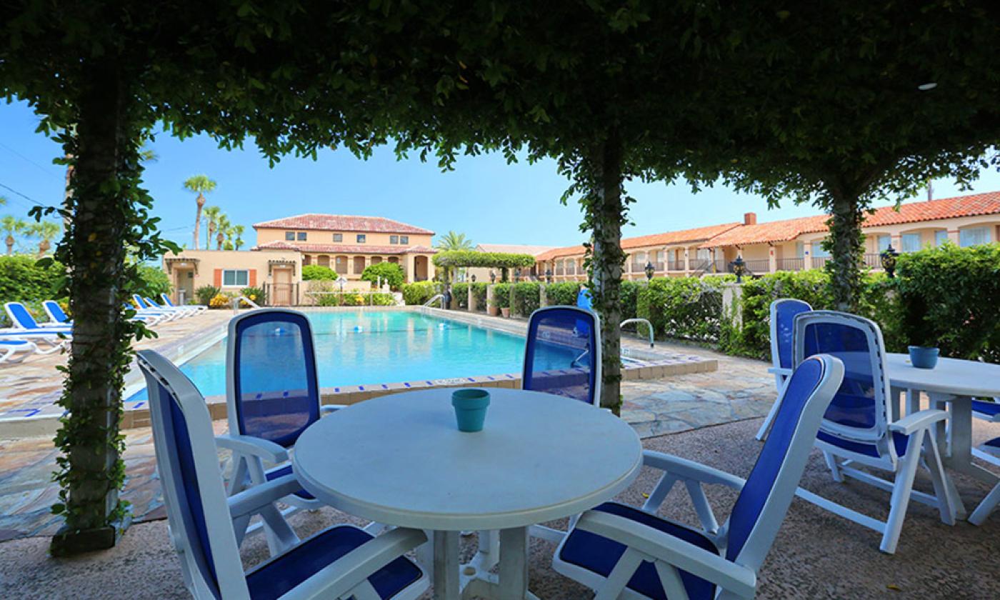 Outdoor seating near the pool at La Fiesta Ocean Inn & Suites