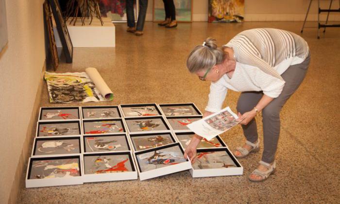 Member of Florida Artist's Group setting up the exhibit.