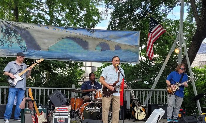 Lightnin Rod & the Thunderbolts play Blues Rock music on stage at outside venue.