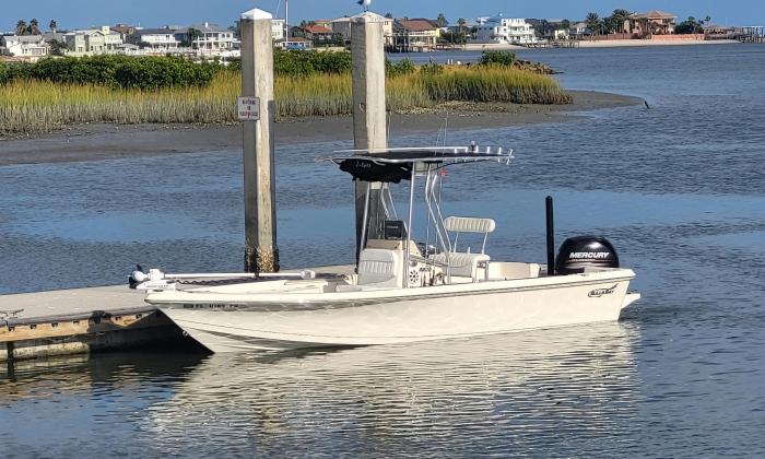 A charter boat is positioned near a dock. 