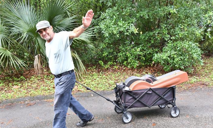 musician Frank Lindamood tows his cartload of instruments to the stage to play.