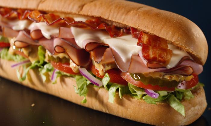 Subway sandwich featuring Black Forest ham, American cheese, hickory-smoked bacon, vegetables, and honey mustard