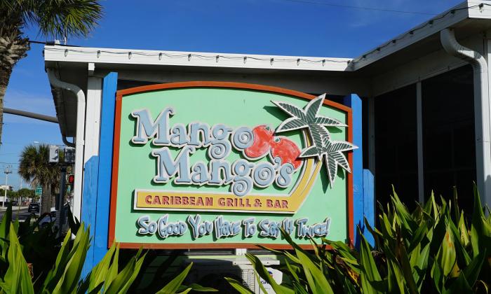 A sign advertising Mango Mango's Caribbean Bar & Grill