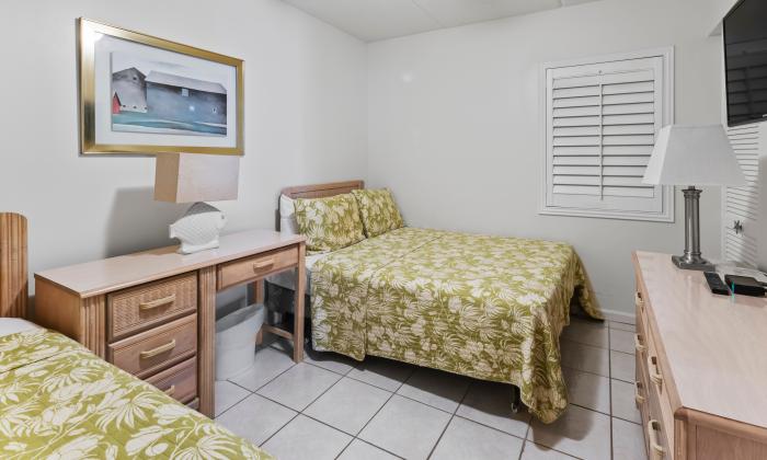 Just Beachy's guest room has one twin and one double bed, a large flat-screen televison and a desk