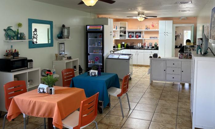 The inside of the eatery with tables and chairs available