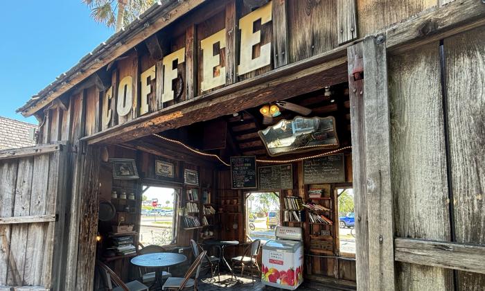 A coffee sign above the entrance doors