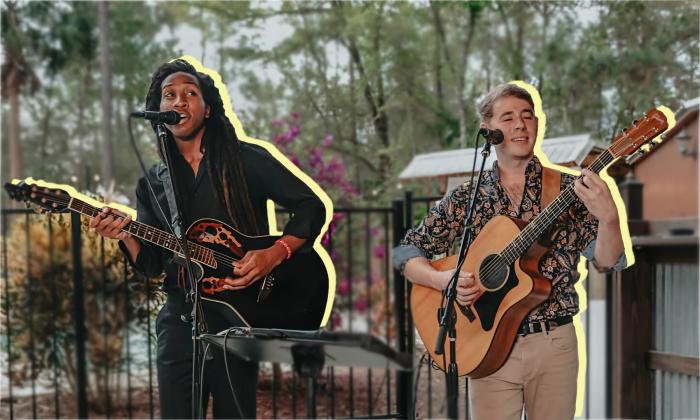 Esh x Schief playing their guitars and singing against a blurred outdoor background.