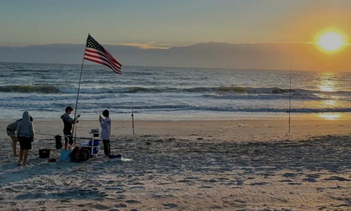 A group of anglers from the Shoreline Showdown Surf Fishing Series at sunset