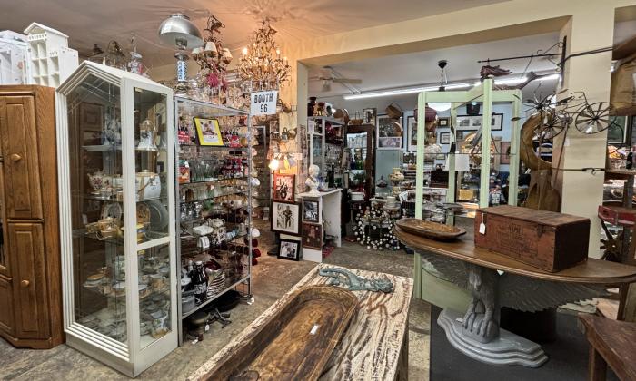 Various furniture pieces and dishware arranged in the back room