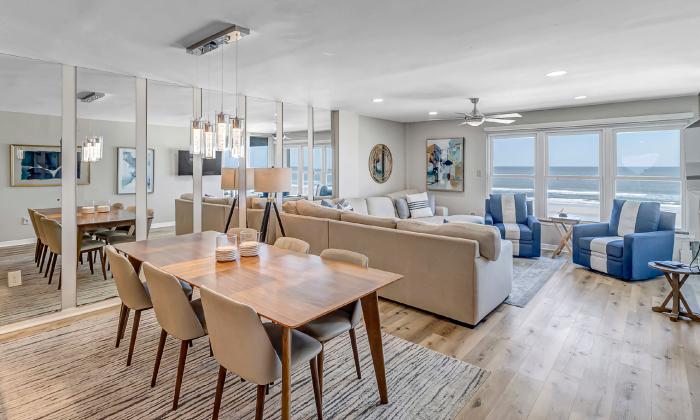 A dining room, living room, and ocean view from an upper-level condo on the beach