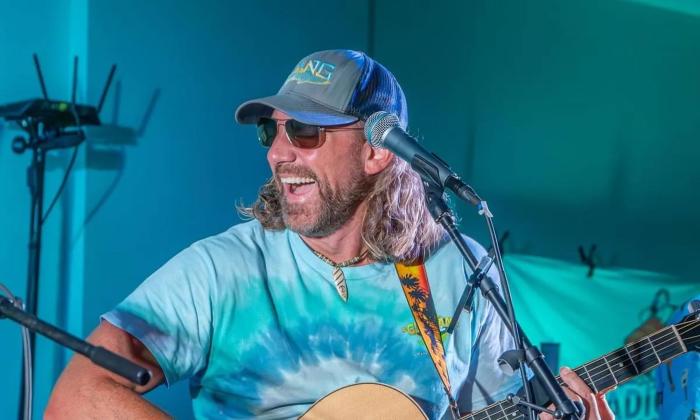 Joe downing singing on stage; phote courtesy of RO Smith Photography