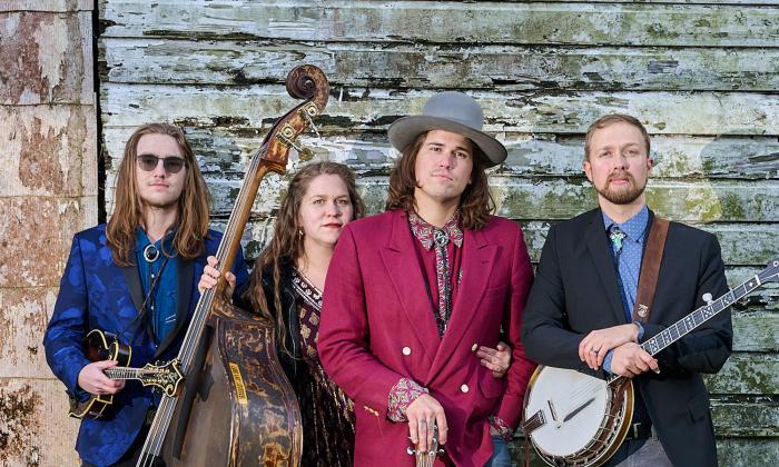 St. Augustine band Remedy Tree, with instruments, standing outside