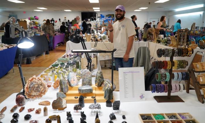 One of the vendors standing behind the displayed products