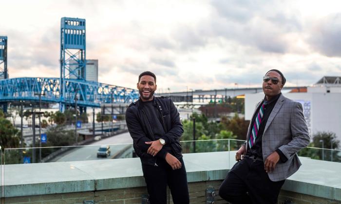 Two members of the Band Big Easy, standing on a rooftop in Jacksonville