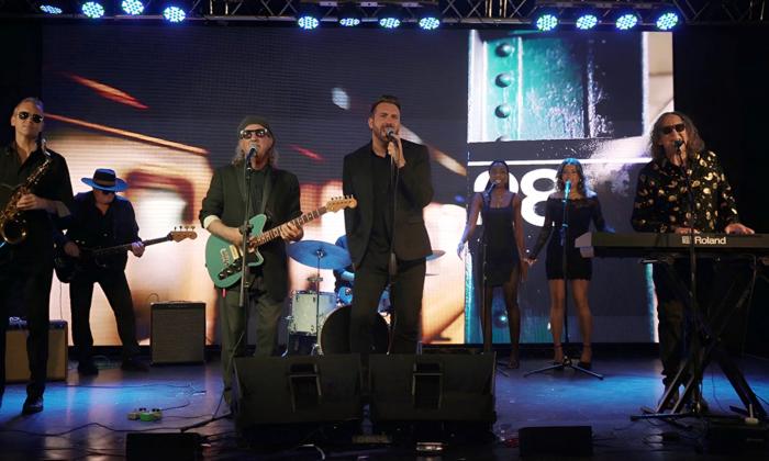 Bandmates from The Expanding Man perform live on stage.