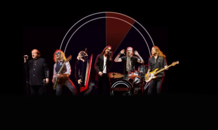 Bandmates from Foreigner pose with their guitars and drums.