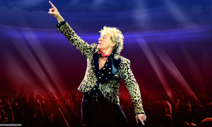 Rod Stewart wears an animal print blazer and performs live on stage.