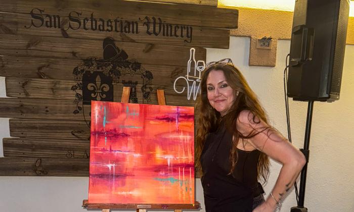 Danielle Torry standing beside her artwork