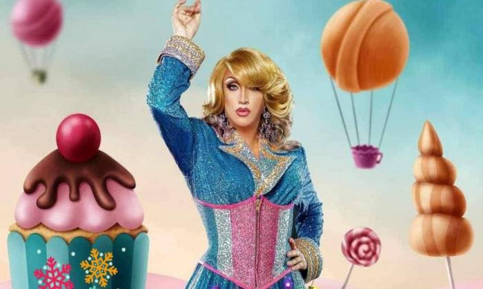 A drag queen next to a cupcake