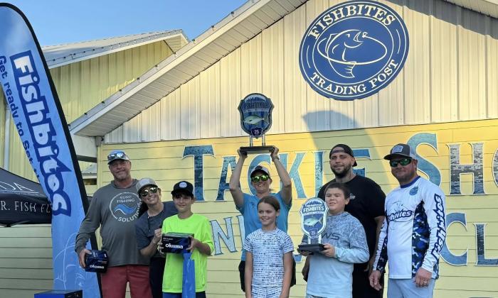 Winners in an onshore fishing tournament show their trophies