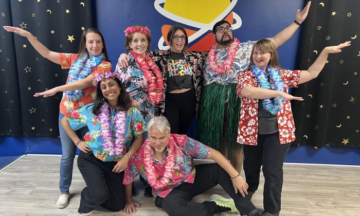A group dress in Hawaiian shirts and leis