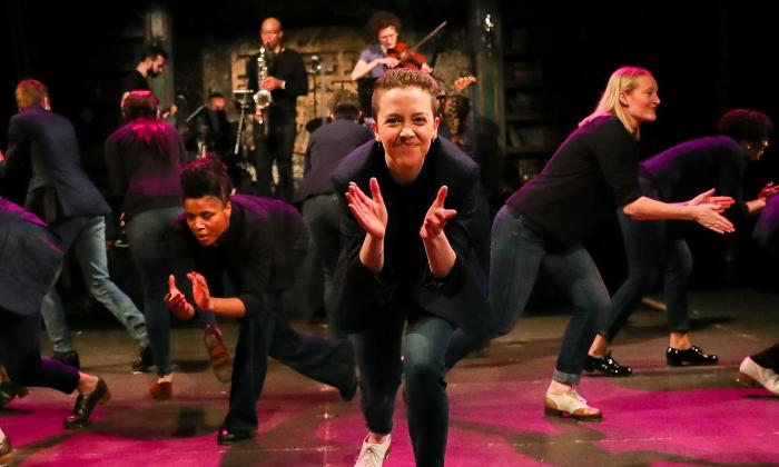 Dancers in Chicago Tap Theater on a red stage in black
