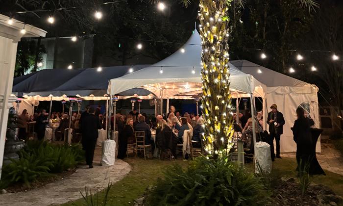 A sit-down dinner under lights at Peña-Peck House