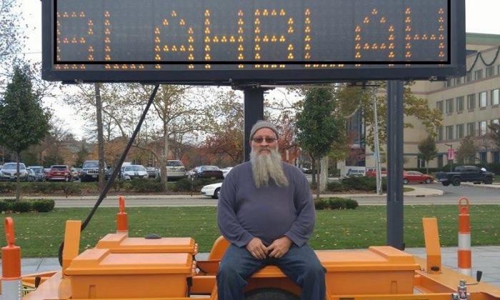 Don Blitch in front of a lighted sign