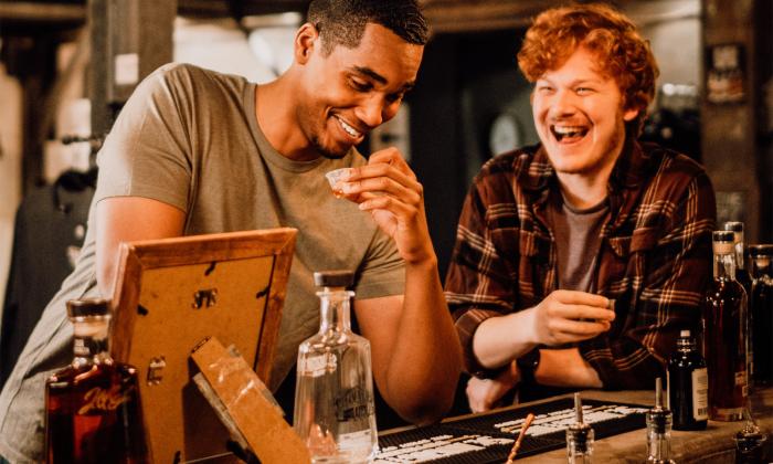 Two visitors enjoy tasting the spirits of the St. Augustine Distillery.