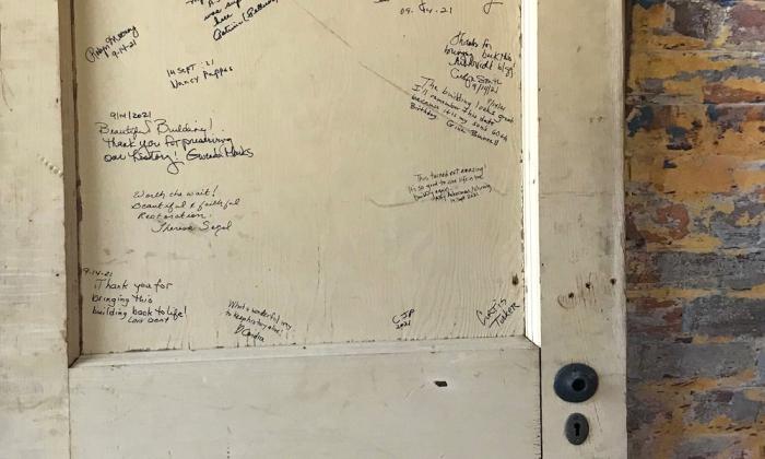 A door filled with "thank you for restoring" notes inside the historic St. Augustine Waterworks.