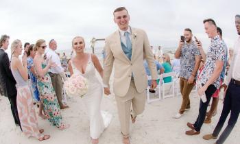 Bride and groom walking hand-in-hand down the aisle after the ceremony