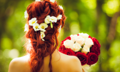 A bride holds a bouquet. 