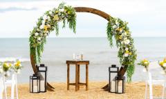 A circular arch decorated with flowers and greenery on both sides