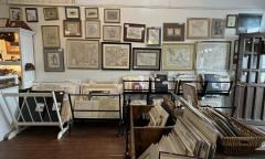 Old prints of maps line the wall inside the shop