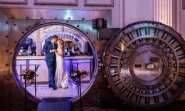 A bridal couple sharing a kiss inside the vault at the Treasury on the Plaza