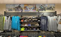 A wall display of hats and shirts by Harley-Davidson