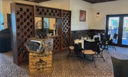 The wine corner at La Cucina Restaurant in St. Augustine, has seating with a view near a collection of wines